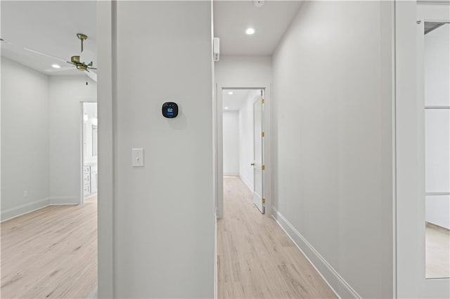 hall with light wood-style floors, baseboards, and recessed lighting