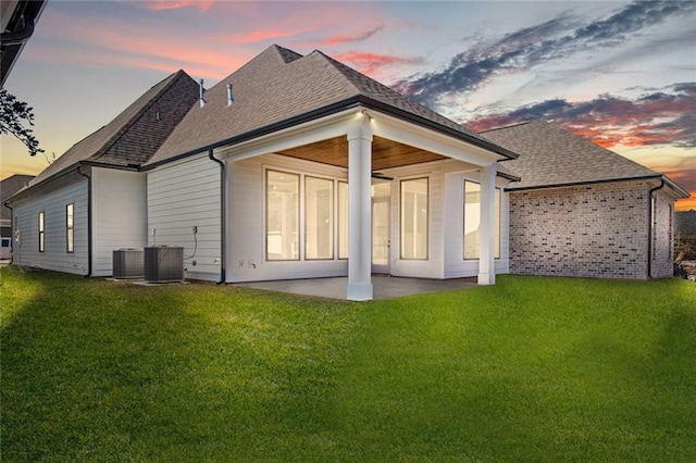 4221 Cypress Point Dr, Covington, LA 70433 - back of property at dusk featuring a patio area, a shingled roof, and a yard