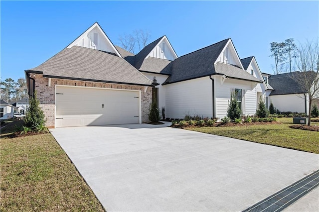 4221 Cypress Point Dr, Covington, LA 70433 - view of front facade featuring board and batten siding, a garage, brick siding, a front lawn, and concrete driveway