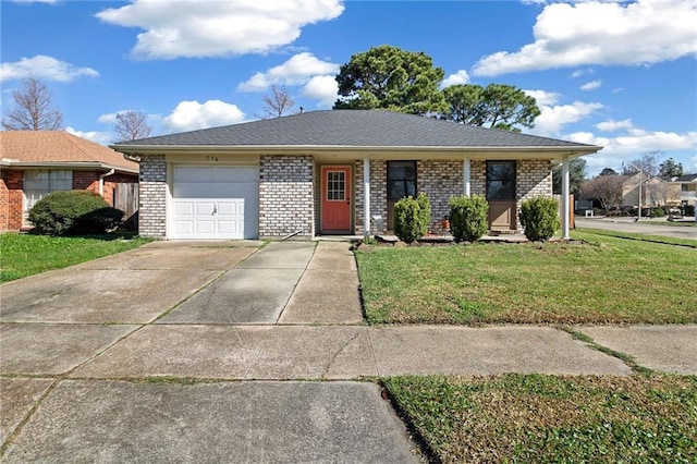 single story home featuring a front lawn, brick siding, driveway, and an attached garage