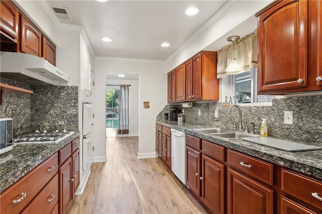 kitchen featuring visible vents, dishwasher, crown molding, stainless steel gas stovetop, and a sink