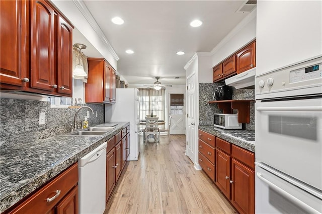 kitchen featuring ceiling fan, under cabinet range hood, white appliances, a sink, and dark countertops