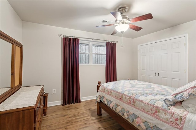 bedroom featuring a ceiling fan, baseboards, visible vents, light wood-style floors, and a closet