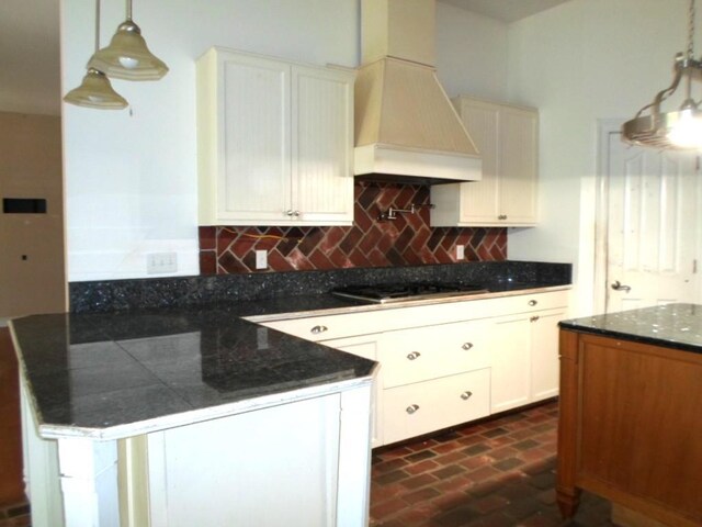 kitchen featuring pendant lighting, white cabinets, decorative backsplash, and black gas stovetop