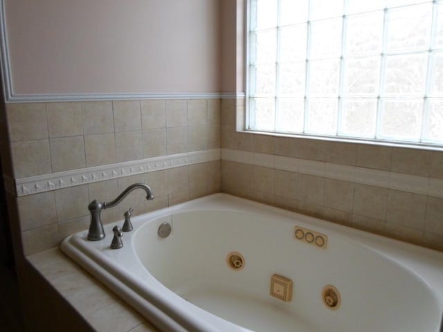 full bath featuring a tub with jets