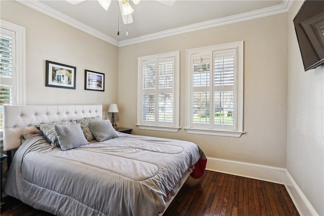 bedroom with baseboards, dark wood-type flooring, multiple windows, and crown molding