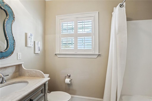 bathroom with toilet, vanity, and a shower with curtain