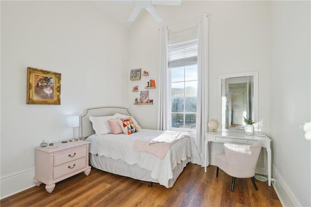 bedroom featuring dark wood-style flooring and baseboards