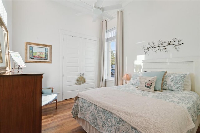 bedroom featuring ceiling fan, a closet, and wood finished floors