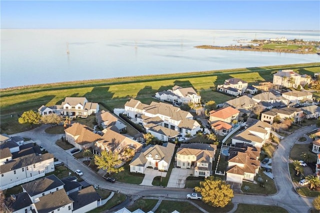 drone / aerial view featuring a water view and a residential view