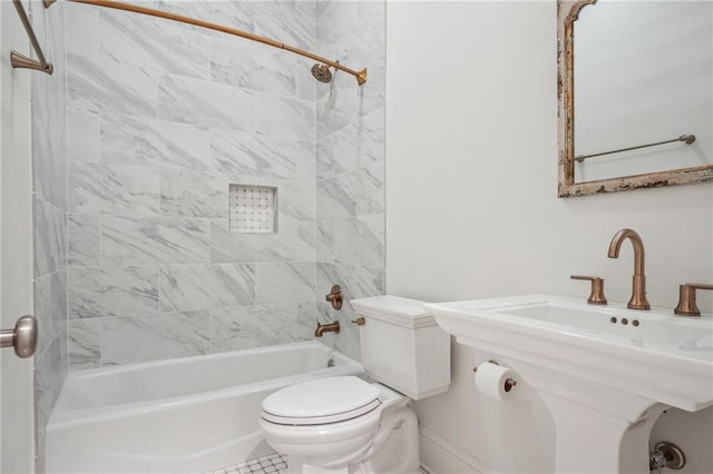 bathroom featuring shower / bathing tub combination and toilet