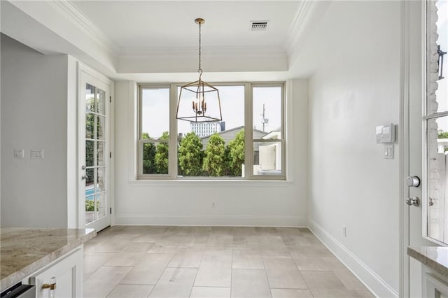 unfurnished dining area with a wealth of natural light, baseboards, a tray ceiling, and crown molding