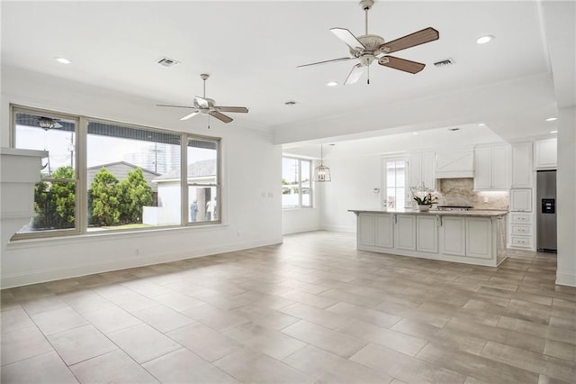 unfurnished living room with baseboards, recessed lighting, visible vents, and a ceiling fan