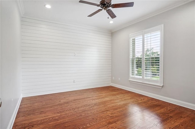 spare room featuring recessed lighting, crown molding, baseboards, and wood finished floors