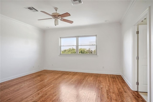 unfurnished room with light wood finished floors, baseboards, visible vents, a ceiling fan, and crown molding