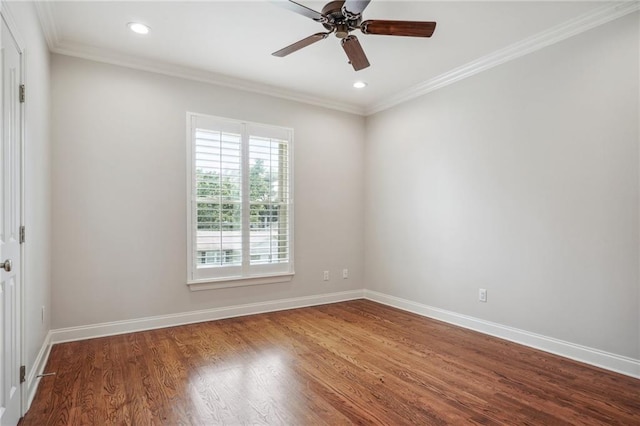 unfurnished room featuring crown molding, wood finished floors, and baseboards