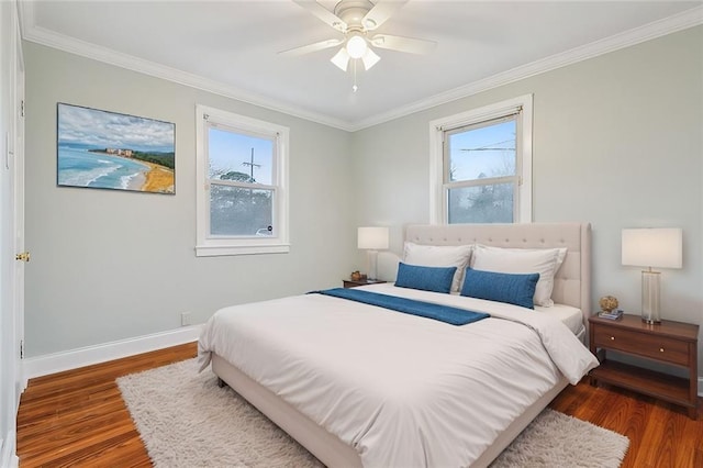 bedroom with crown molding, multiple windows, dark wood-style flooring, and baseboards