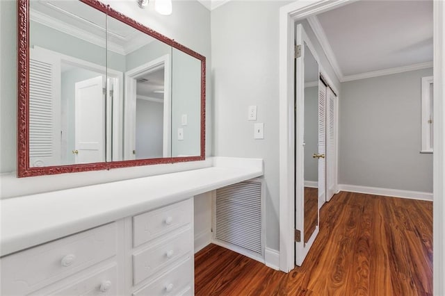 interior space featuring ornamental molding, visible vents, baseboards, and wood finished floors