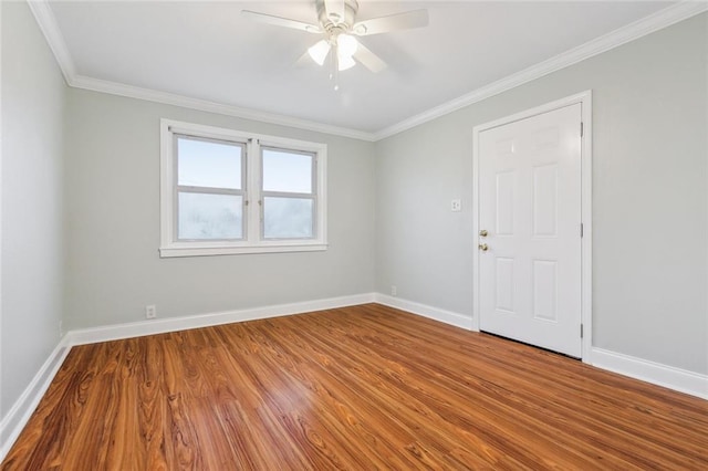 unfurnished room featuring crown molding, baseboards, ceiling fan, and wood finished floors