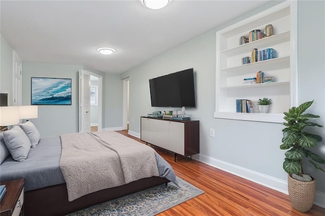 bedroom featuring baseboards and wood finished floors