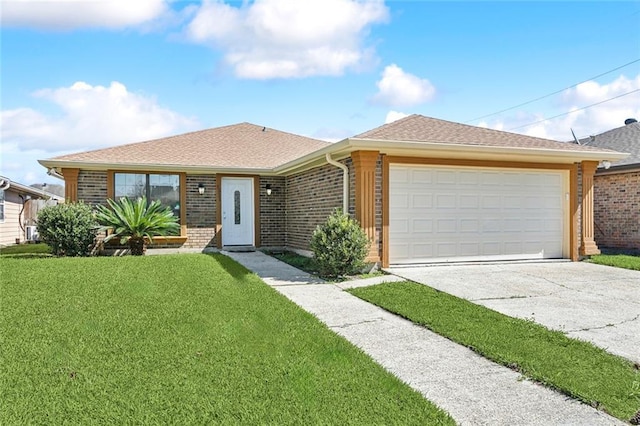 single story home with a garage, a front yard, concrete driveway, and brick siding