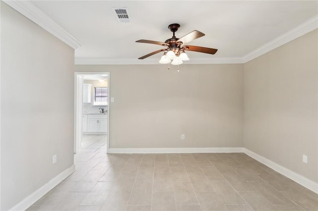 empty room with ceiling fan, ornamental molding, visible vents, and baseboards