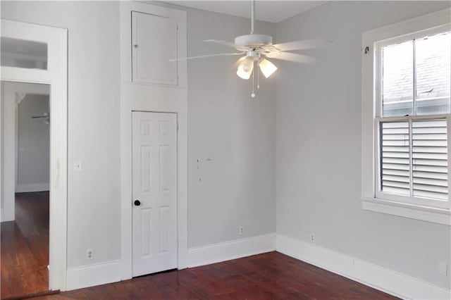 unfurnished bedroom featuring dark wood-type flooring and baseboards