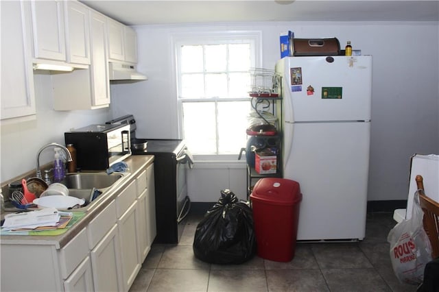 kitchen featuring freestanding refrigerator, white cabinets, a sink, range with electric cooktop, and under cabinet range hood