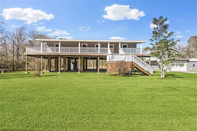 rear view of property featuring stairs and a yard