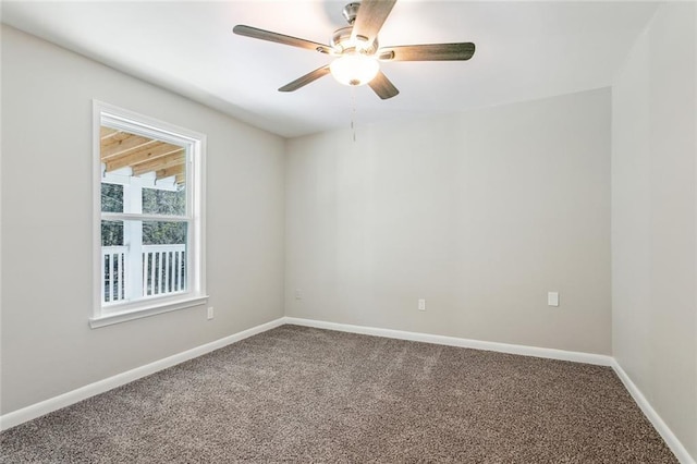 unfurnished room with carpet floors, baseboards, and a ceiling fan