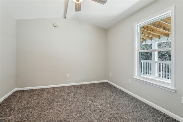 empty room with a ceiling fan, carpet, vaulted ceiling with beams, and baseboards