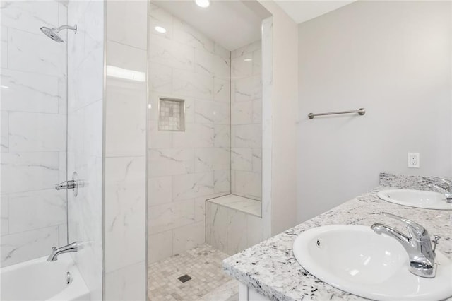 bathroom with tub / shower combination, a sink, and double vanity