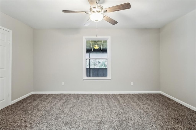 carpeted spare room with ceiling fan and baseboards