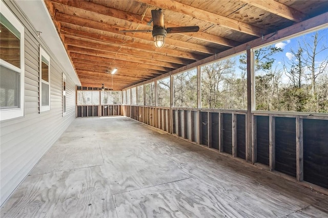 unfurnished sunroom with a ceiling fan