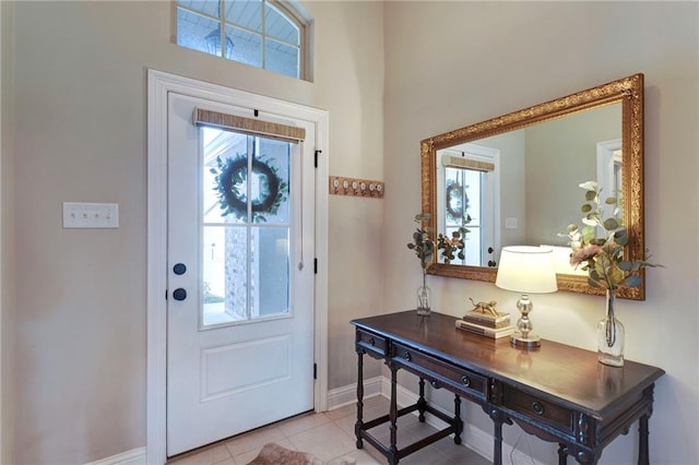 entrance foyer featuring baseboards and light tile patterned floors