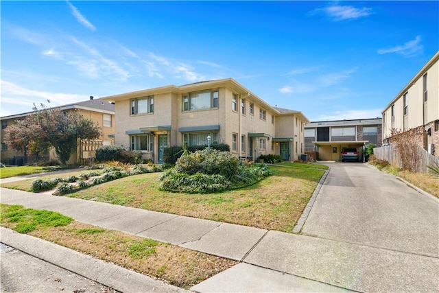 view of property with fence, a front lawn, and concrete driveway