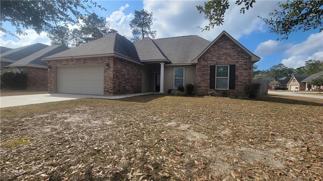 view of front of home featuring a garage, driveway, and brick siding