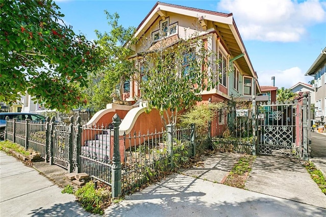 view of front facade with a fenced front yard and a gate