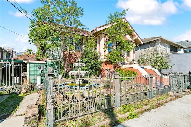 obstructed view of property with a fenced front yard