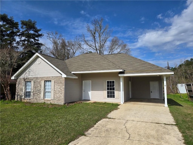 ranch-style house with driveway, a front lawn, an attached carport, and brick siding