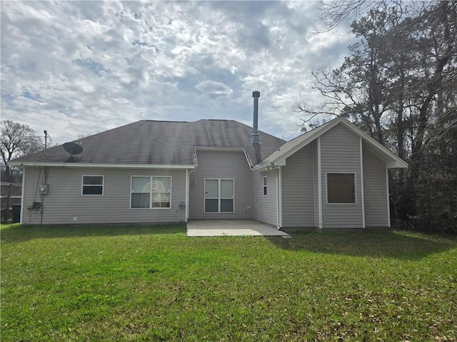 back of property featuring a patio area and a yard