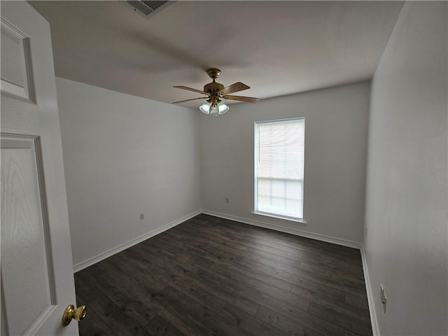 unfurnished room with baseboards, ceiling fan, visible vents, and dark wood-type flooring