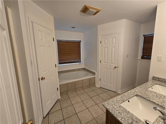 full bathroom with double vanity, visible vents, a garden tub, tile patterned flooring, and a sink