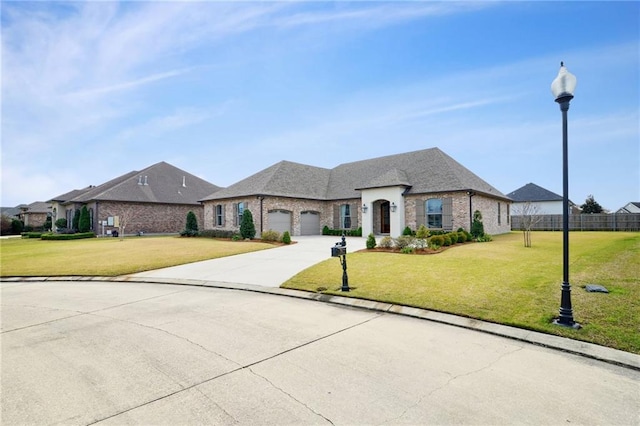 french provincial home with driveway, a front lawn, an attached garage, and fence