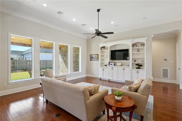 living area with visible vents, ornamental molding, and dark wood finished floors