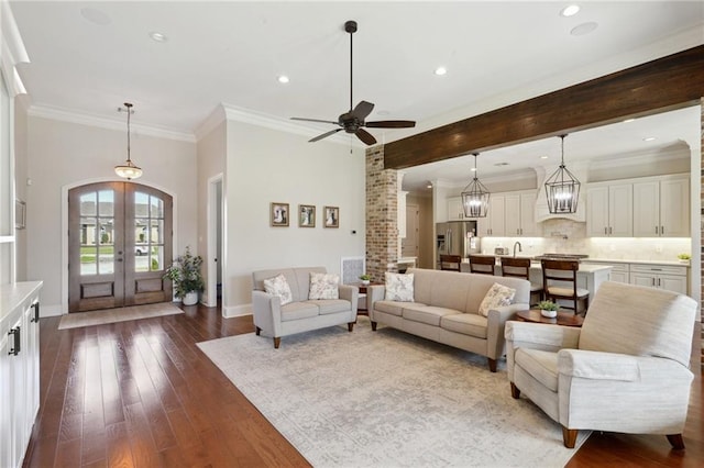 living room with ornamental molding, french doors, dark wood-type flooring, and baseboards