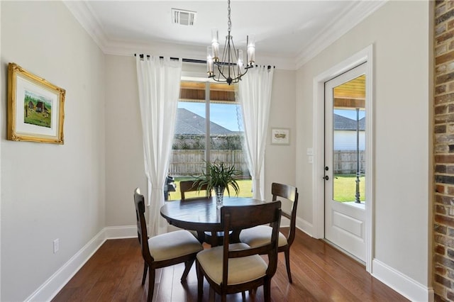 dining area featuring a mountain view, dark wood-type flooring, visible vents, and a healthy amount of sunlight