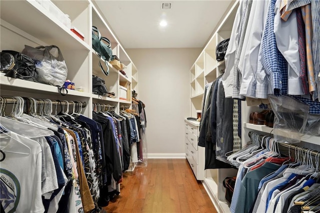 spacious closet featuring wood finished floors and visible vents