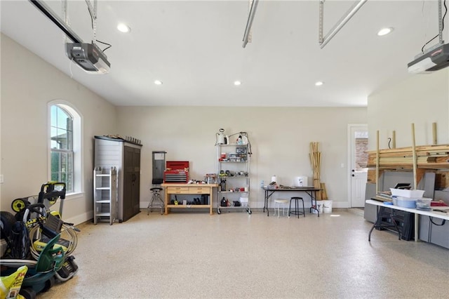 garage featuring baseboards, a workshop area, recessed lighting, and a garage door opener