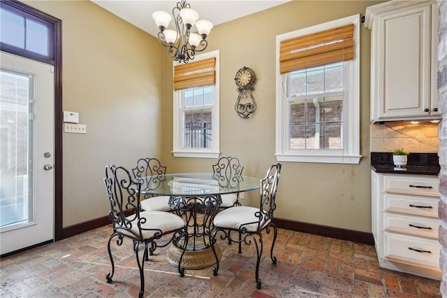 dining room with baseboards and an inviting chandelier